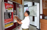 A man reads NPC’s anti-torture poster in Gampaha