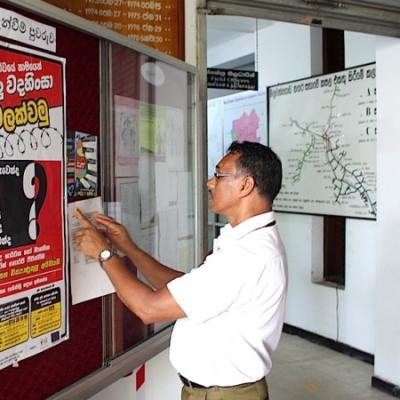 A Man Reads Npcs Anti Torture Poster In Gampaha